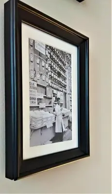 a black and white photo of a woman working in a bakery at More Athens Apartments in Athens