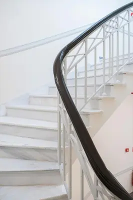 a stairwell with white stairs and a hand rail at Athens Psiri Hotel in Athens