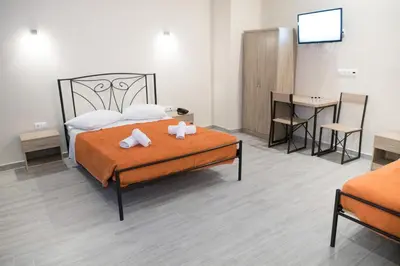 a bedroom with a bed with two towels on it at Athens Psiri Hotel in Athens