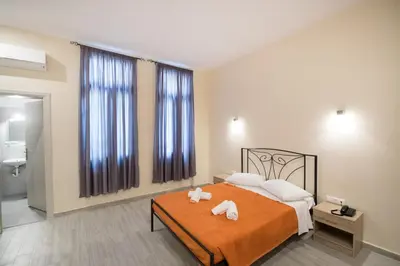 a bedroom with a bed with two towels on it at Athens Psiri Hotel in Athens