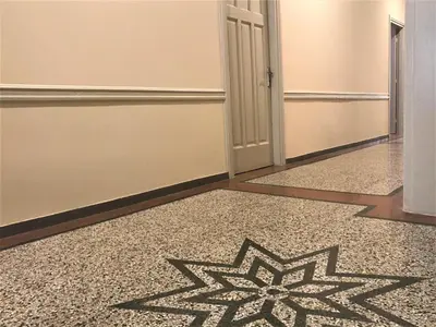 a hallway with a carpet with a star pattern on the floor at Athens Psiri Hotel in Athens