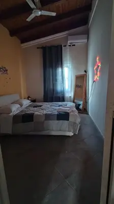 a bedroom with a bed with a light on the wall at Near AirportAnd metropolitan Penelopi Cozy Home in Artemida