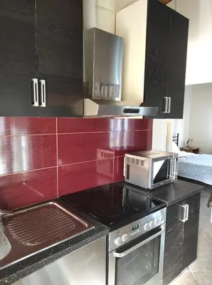 a kitchen with a microwave and a stove top oven at Near AirportAnd metropolitan Penelopi Cozy Home in Artemida