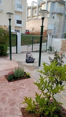 a garden with two street lights and a vacuum at Near AirportAnd metropolitan Penelopi Cozy Home in Artemida