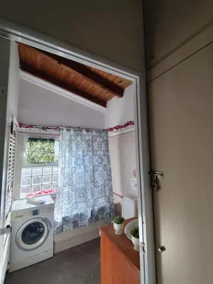 a kitchen with a washing machine and a window at Near AirportAnd metropolitan Penelopi Cozy Home in Artemida