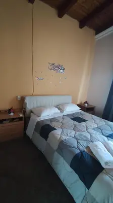 a bedroom with a bed and a wall with a painting at Near AirportAnd metropolitan Penelopi Cozy Home in Artemida