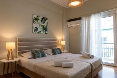 a bedroom with a large bed with two pillows on it at Paradise apartment in Koukaki in Athens