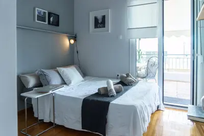 a bedroom with a bed with a laptop on it at Small & cozy with Acropolis & Lycabettus view in Athens