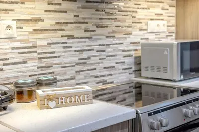 a kitchen with a counter with a house sign on it at Leo's home in Athens