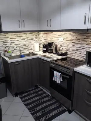 a kitchen with a stove and a sink at Leo's home in Athens