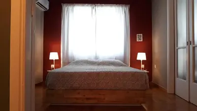 a bedroom with a bed and a large window at Kanigos 3 BR VIEW Center of Athens in Athens