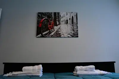 a bedroom with a bed with a picture on the wall at Kanigos 3 BR VIEW Center of Athens in Athens