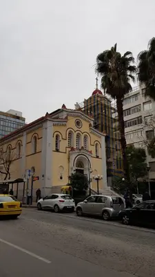 a building with cars parked on the side of a street at Kanigos 3 BR VIEW Center of Athens in Athens