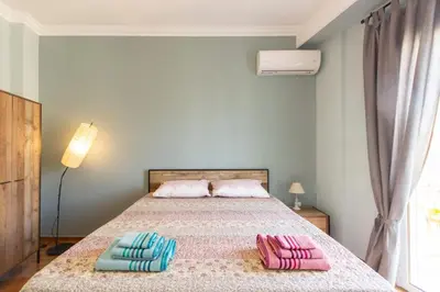 a bedroom with a bed with two pillows on it at Kanigos 3 BR VIEW Center of Athens in Athens