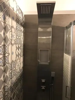 a bathroom with a shower with black and white tiles at Kanigos 3 BR VIEW Center of Athens in Athens