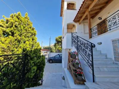 a stairway leading up to a house with flowers at The Mirador Boutique Villa with Scenic Sea View in Porto Rafti
