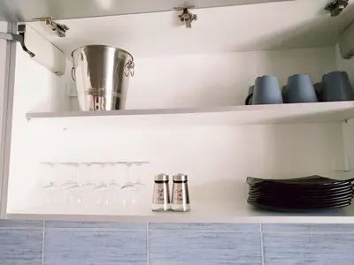 a shelf with wine glasses and plates on it at The Athens Museum Penthouse 120sqm Lycabettus View in Athens