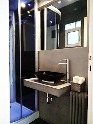 a bathroom with a black sink and a mirror at The Athens Museum Penthouse 120sqm Lycabettus View in Athens
