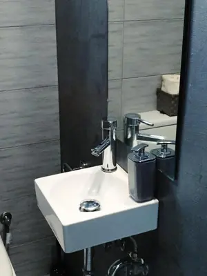 a bathroom with a white sink and a mirror at The Athens Museum Penthouse 120sqm Lycabettus View in Athens