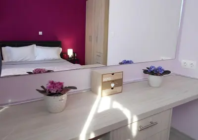 a bedroom with a bed with purple walls and flowers at MiCasa SuCasa / Heart of Athens / Brand-New superlux in Athens