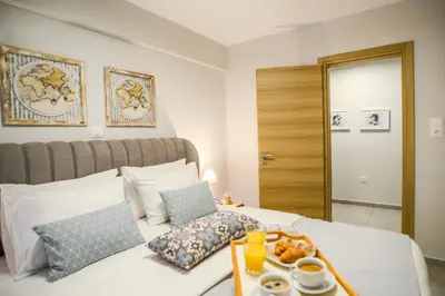 a bedroom with a bed with a tray of food on it at Your Home Away from Home in Erectheium in Athens