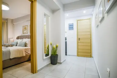 a bedroom with a bed and a hallway with a door at Your Home Away from Home in Erectheium in Athens