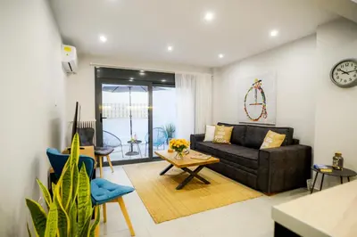 a living room with a couch and a table at Your Home Away from Home in Erectheium in Athens