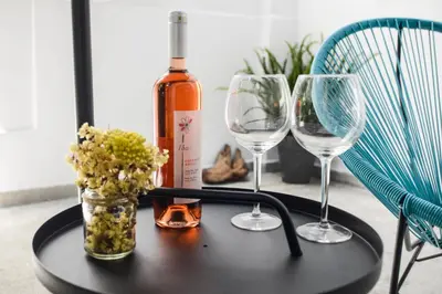 a table with two wine glasses and a bottle of wine at Your Home Away from Home in Erectheium in Athens