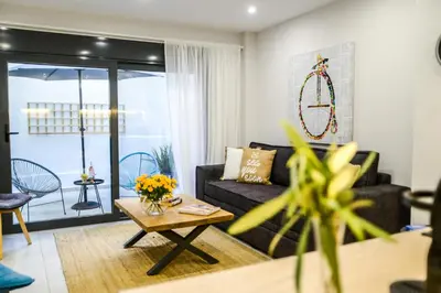 a living room with a couch and a table at Your Home Away from Home in Erectheium in Athens