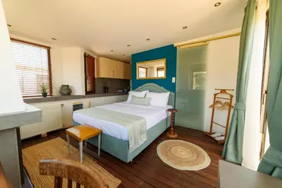 a bedroom with a large bed with a blue headboard at Acropolis Eye Loft in Athens