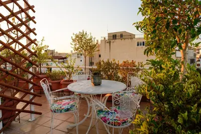 a patio with a table and chairs on a balcony at Acropolis Eye Loft in Athens
