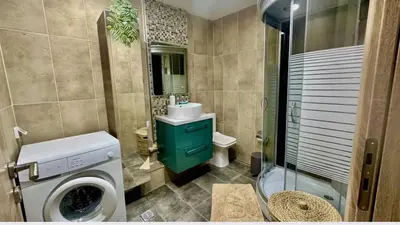 a bathroom with a washing machine and a washer at Acropolis Modern Apartments free parking,free pet hosting,Netflix in Athens