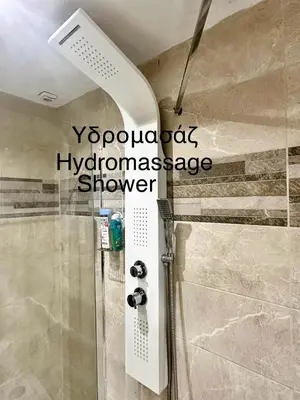 a shower with a glass door in a bathroom at Acropolis Modern Apartments free parking,free pet hosting,Netflix in Athens