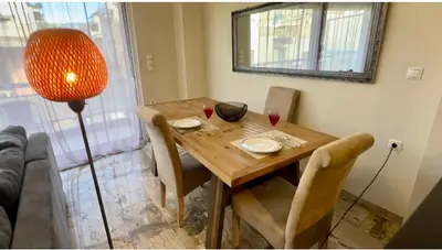 a dining room table with two glasses of red wine at Acropolis Modern Apartments free parking,free pet hosting,Netflix in Athens