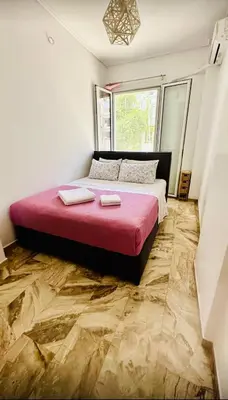 a bedroom with a large bed with a red blanket at Acropolis Modern Apartments free parking,free pet hosting,Netflix in Athens