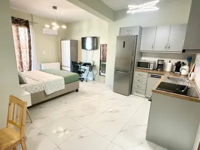 a kitchen with a bed and a sink in a room at Acropolis Modern Apartments free parking,free pet hosting,Netflix in Athens