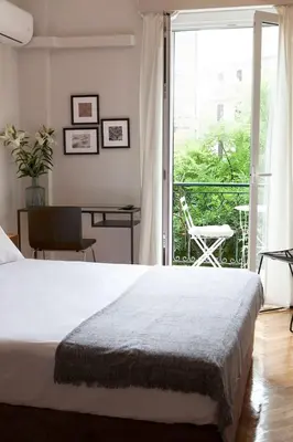 a bedroom with a bed and a view of a balcony at Chic & Comfortable Central Apart, close to National Archeological Museum! in Athens