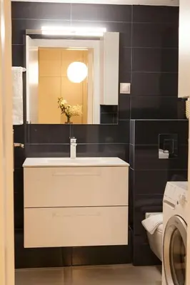 a bathroom with a sink and a mirror and a toilet at Chic & Comfortable Central Apart, close to National Archeological Museum! in Athens