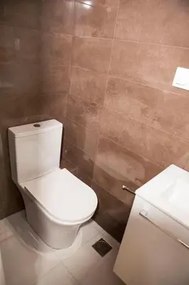 a bathroom with a white toilet and a sink at Chic & Comfortable Central Apart, close to National Archeological Museum! in Athens