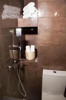 a bathroom with a toilet and a bunch of towels at Chic & Comfortable Central Apart, close to National Archeological Museum! in Athens