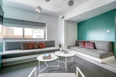 a living room with a couch and two tables at Athens Color Cube in Athens