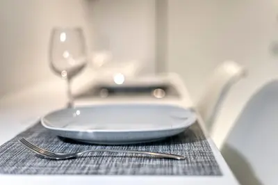 a plate on a table with a knife and fork at Athens Color Cube in Athens