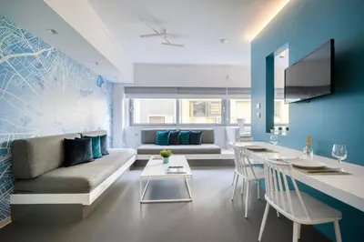 a living room with a couch and a table at Athens Color Cube in Athens