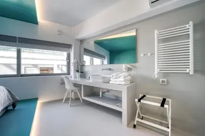 a bathroom with a sink and a mirror at Athens Color Cube in Athens