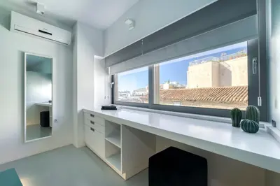 a white room with a window and a white desk at Athens Color Cube in Athens