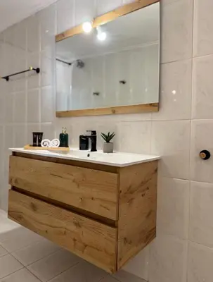 a bathroom with a sink and a mirror at Kalliopi's apartment in Athens