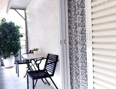 a patio with a table and chairs on a balcony at Kalliopi's apartment in Athens