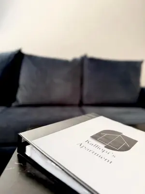 a book sitting on top of a table with a couch at Kalliopi's apartment in Athens