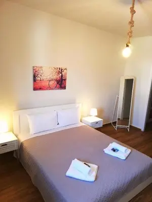 a bedroom with a bed with two towels on it at Comfortable Apartment Close to the Airport in Spáta