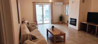 a living room with a couch and a table at Comfortable Apartment Close to the Airport in Spáta